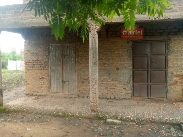 50x100 Land in Hima town council - Near the highway and in busy area - Six rooms - Inside is plastered and floor cemented - Electricity and water available